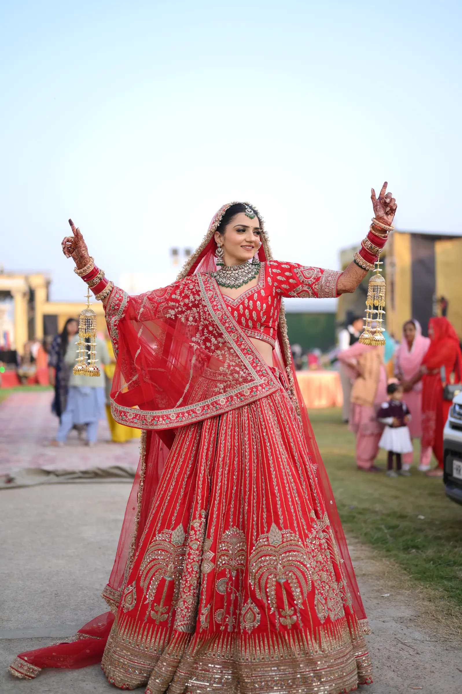 Bride dancing with her arms raised during the celebrations