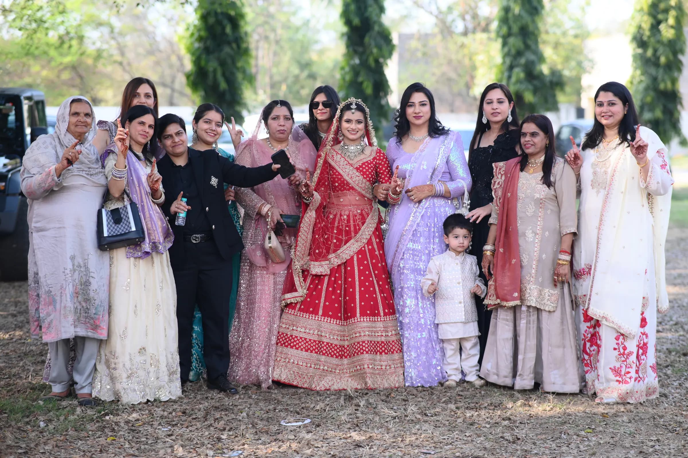 Bride celebrating with the women of her family in an outdoor group photo