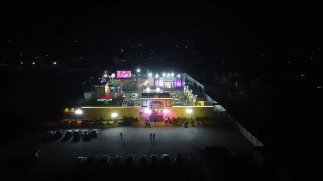 Aerial drone shot of a lit-up wedding venue at night