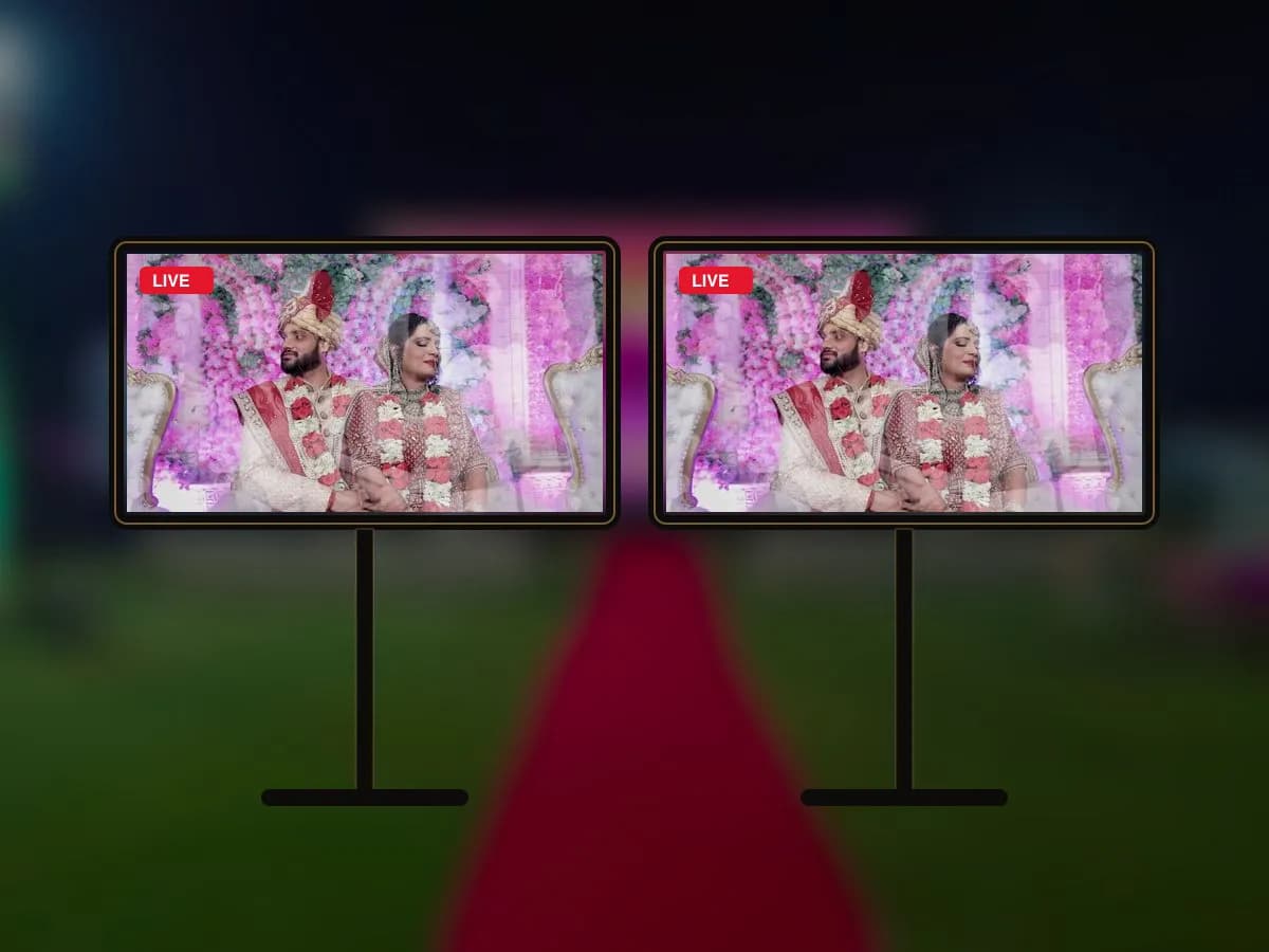The live feed of a wedding couple shown on two 43-inch LED screens