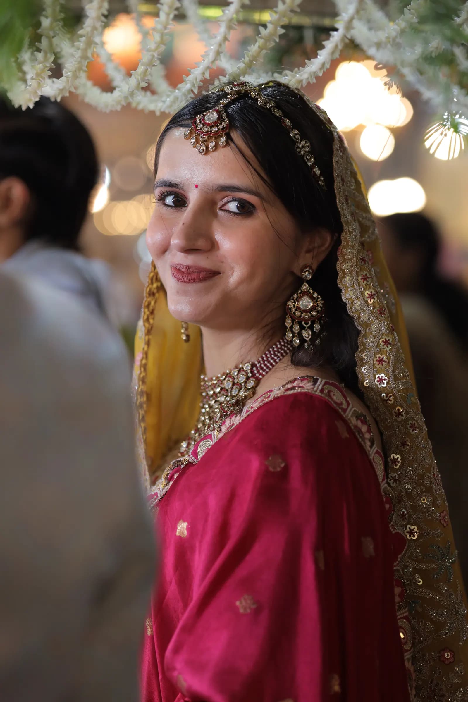 Candid photo of a bride smiling over her shoulder
