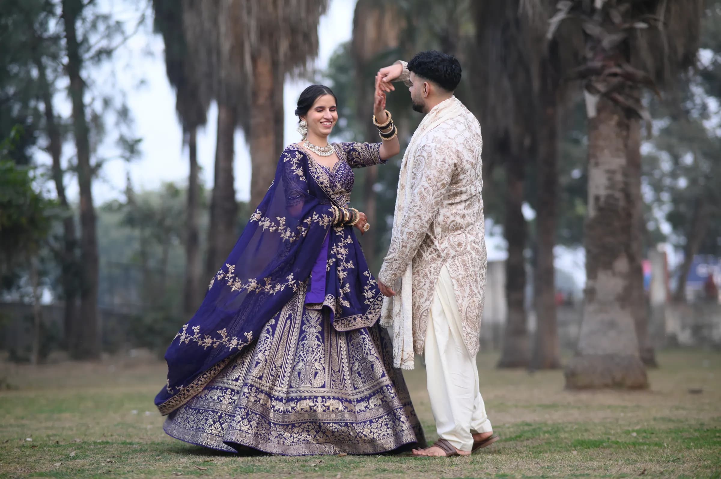 Pre-wedding shoot: groom twirling the bride in a park