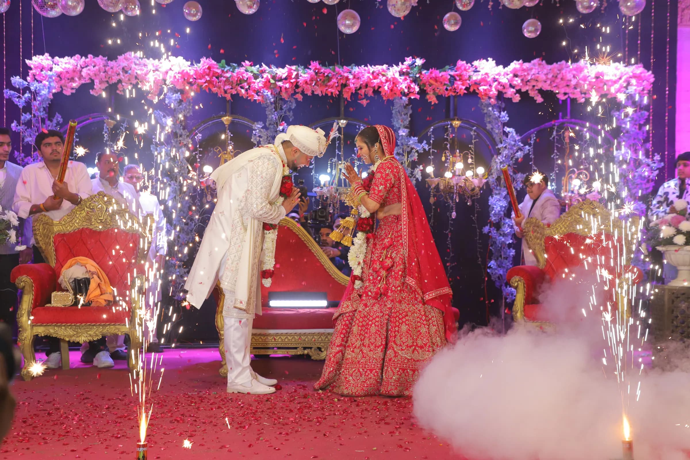 Varmala on a decorated stage with sparklers at a Haryana wedding
